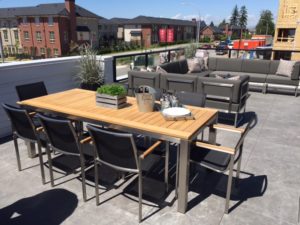 Patio Furniture displayed with teak wood dining table and Naples sectional