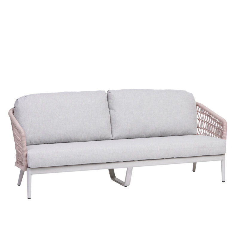 the poinciana pink collection ratana sofa with white cushions.